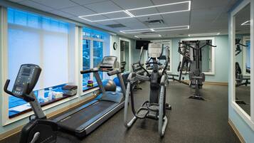 A gym with treadmills, an elliptical, and weight machines.