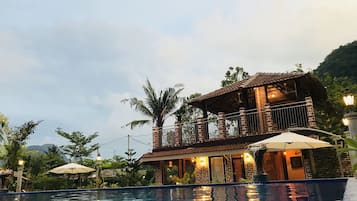 A two-story building with a pool in front.