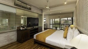 A modern hotel room with a large bed, a television, a desk, and a balcony with a view. - Rockwell Colombo (Colombo)