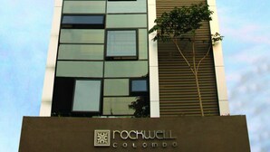 A modern building with a glass facade and a sign reading "Rockwell Colombo". - Rockwell Colombo (Colombo)