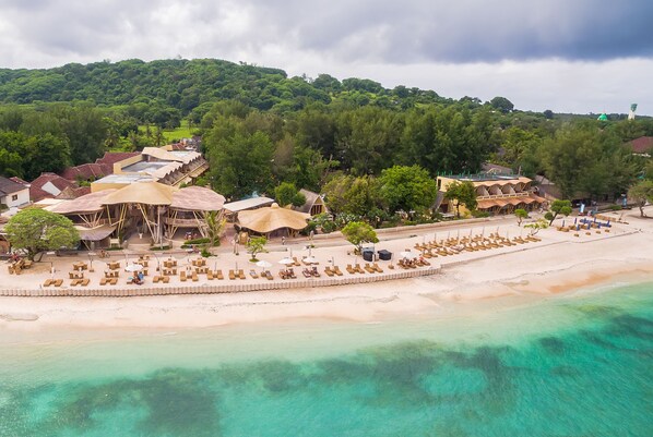 On the beach, white sand, sun-loungers, beach umbrellas