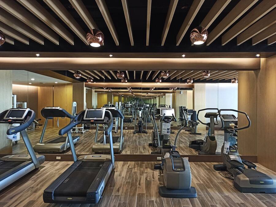 A gym with treadmills, ellipticals, and other cardio equipment.