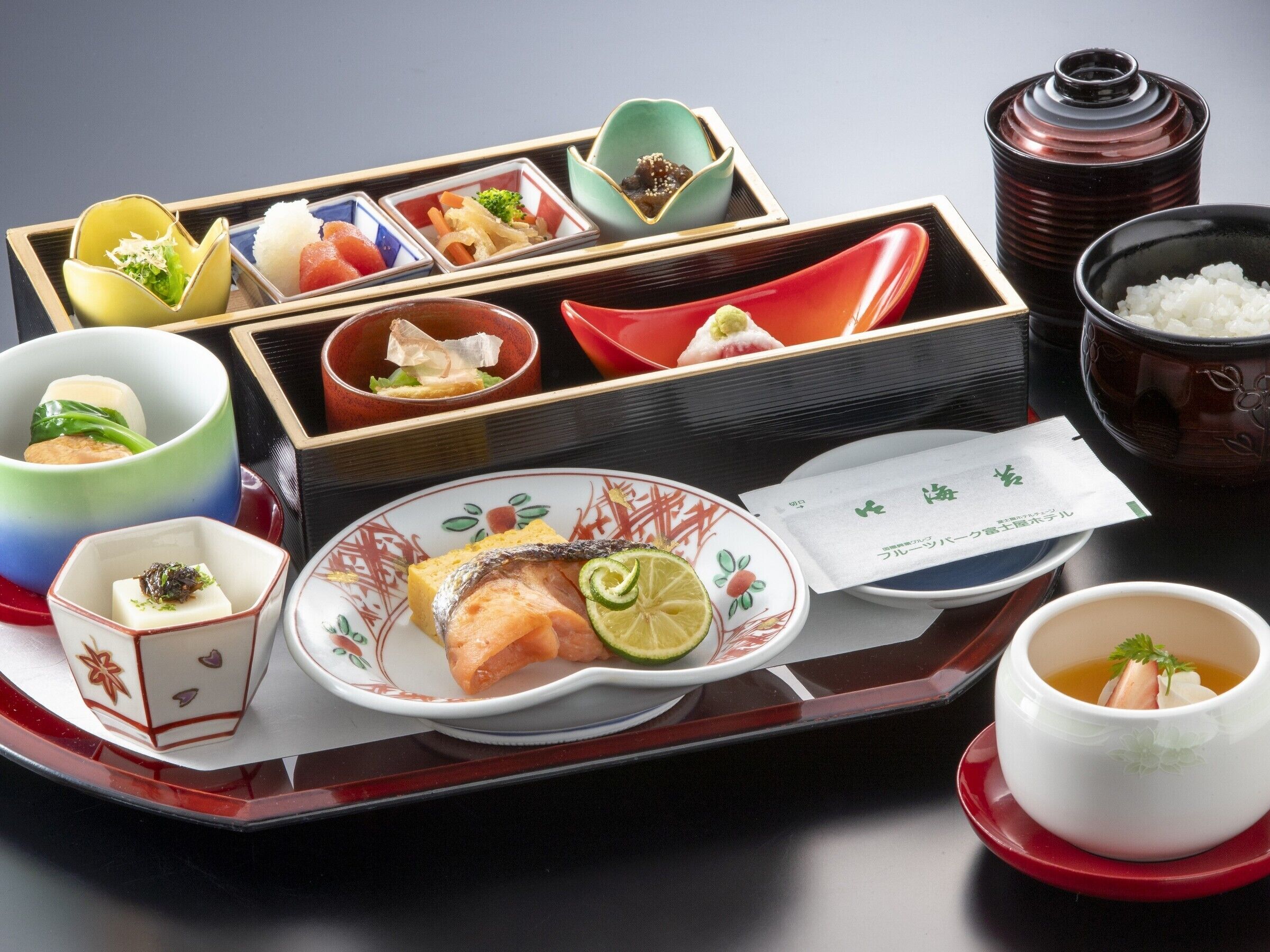 A traditional Japanese meal setup with various dishes and utensils.
