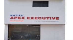 A hotel sign with the name "Apex Executive".