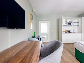 Extra Large Studio with Kitchenette | Living area | 43-inch flat-screen TV with cable channels, TV, streaming services