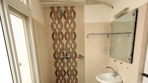 A bathroom with a window, a sink, and a mirror. - De Hotel Veda (Kathmandu)