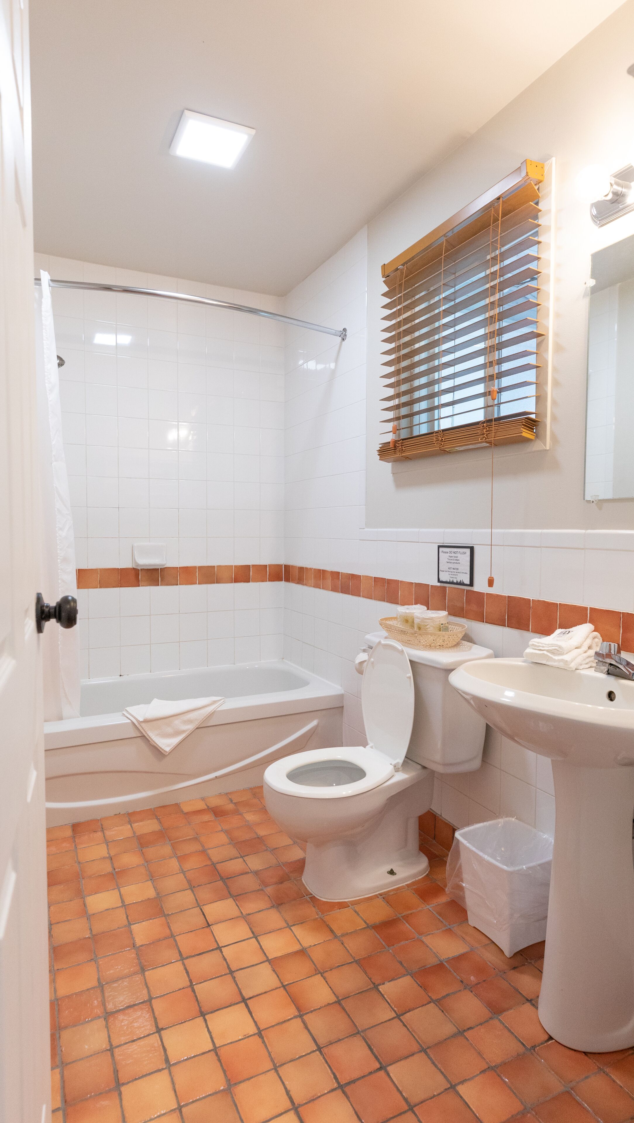 A bathroom with a shower, toilet, bathtub, and sink.