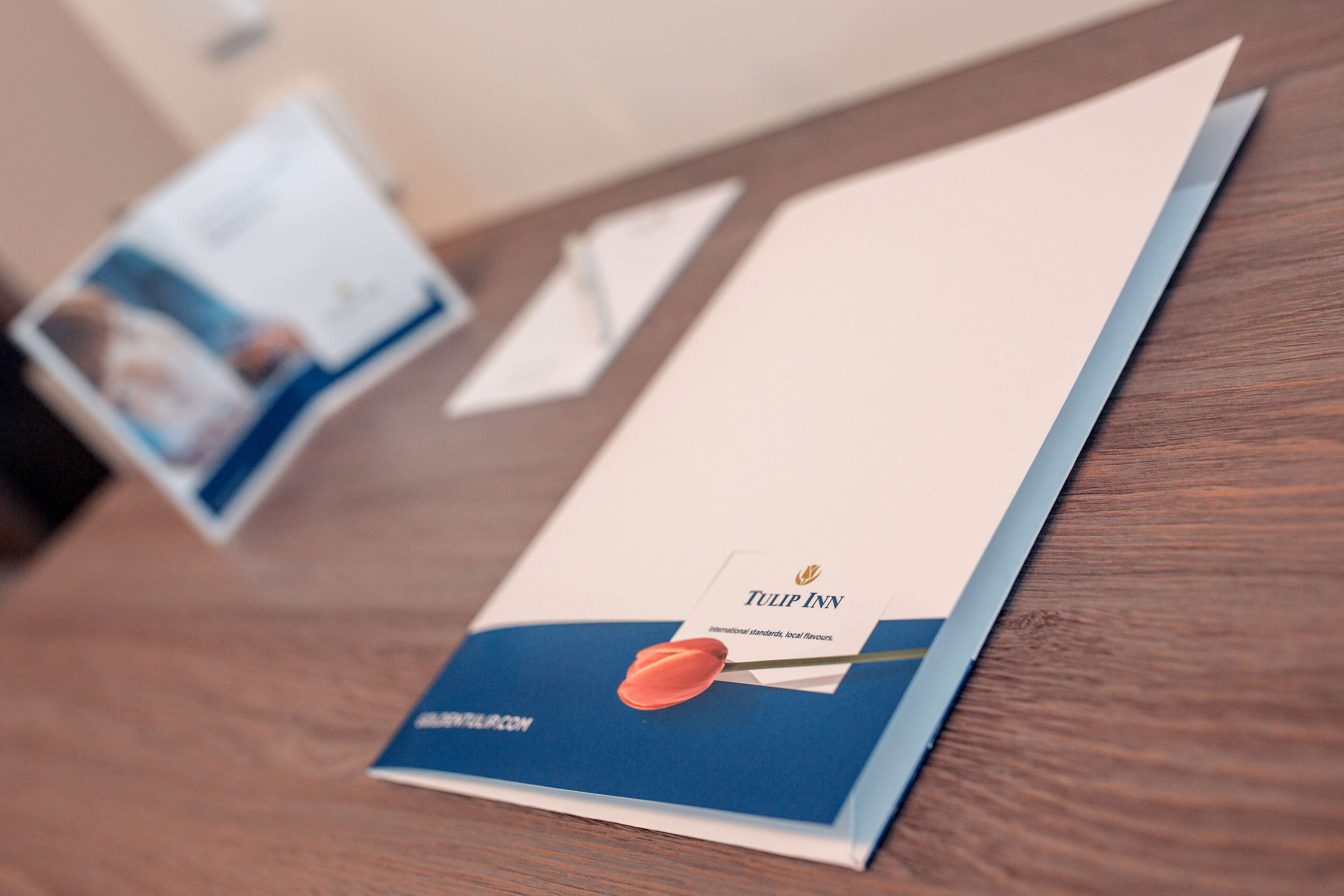 A brochure with the Tulip Inn logo and a red tulip illustration.