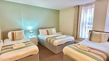 Premium Quadruple Room | Blackout curtains, bed sheets