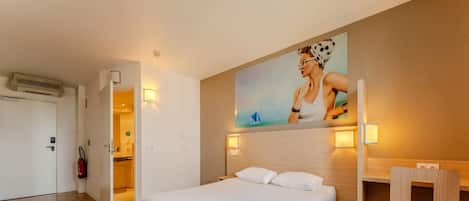 Premium bedding, desk, laptop workspace, blackout drapes