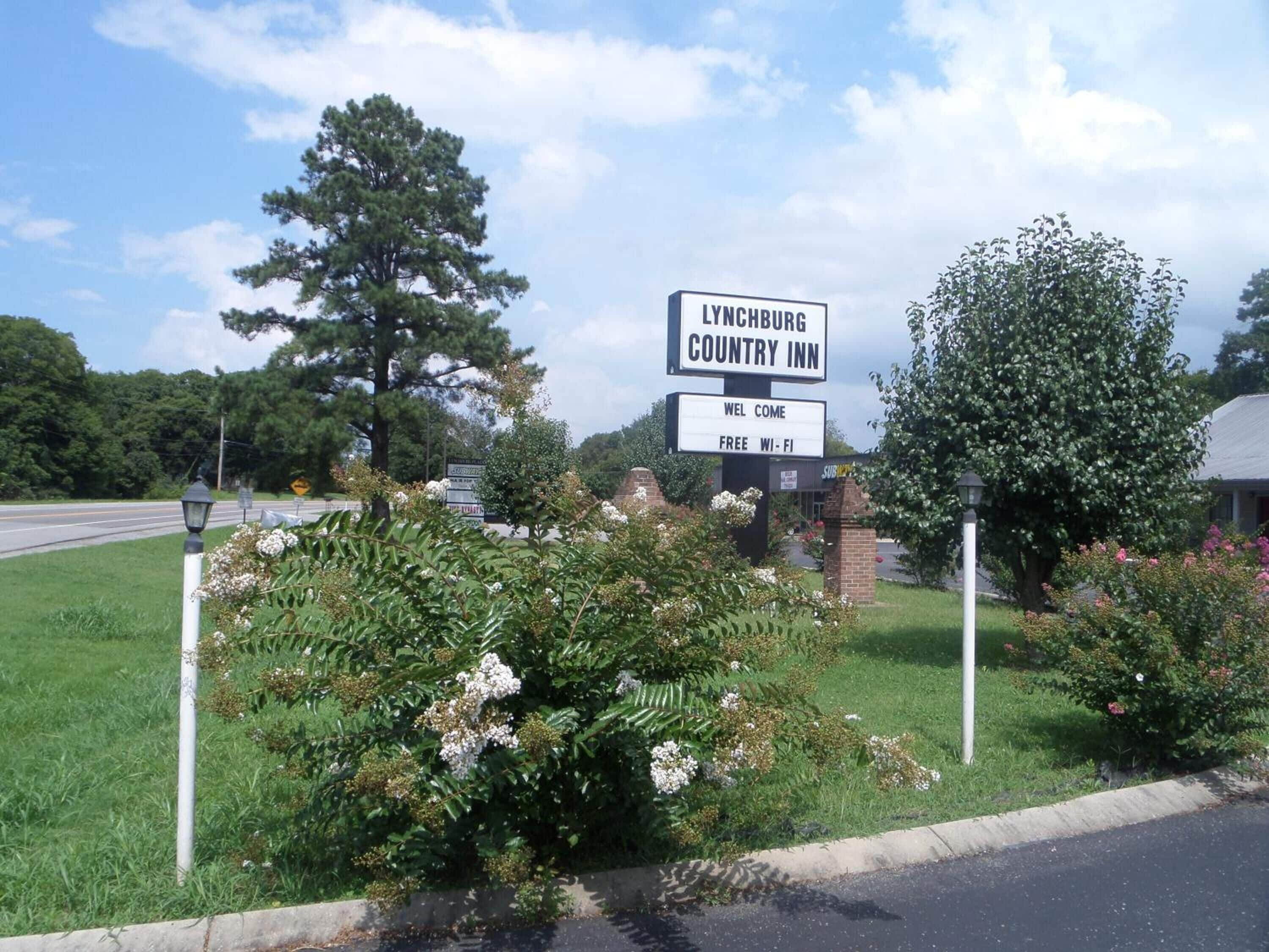 A sign for Lynchburg Country Inn with a welcoming message and free Wi-Fi.