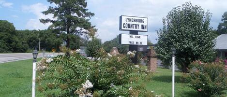 A sign for Lynchburg Country Inn with a welcoming message and free Wi-Fi.