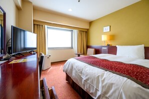 A hotel room with a bed, a desk with a television, a desk lamp, and a window with curtains. - Fukuyama New Castle Hotel (Fukuyama)