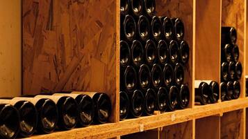 A storage area with shelves containing multiple wine bottles.