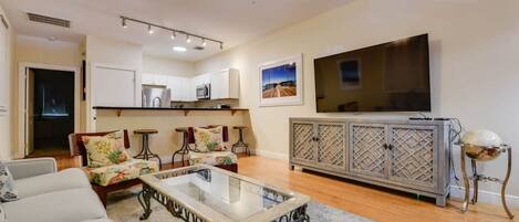 A modern living room with a sofa, coffee table, and TV.
