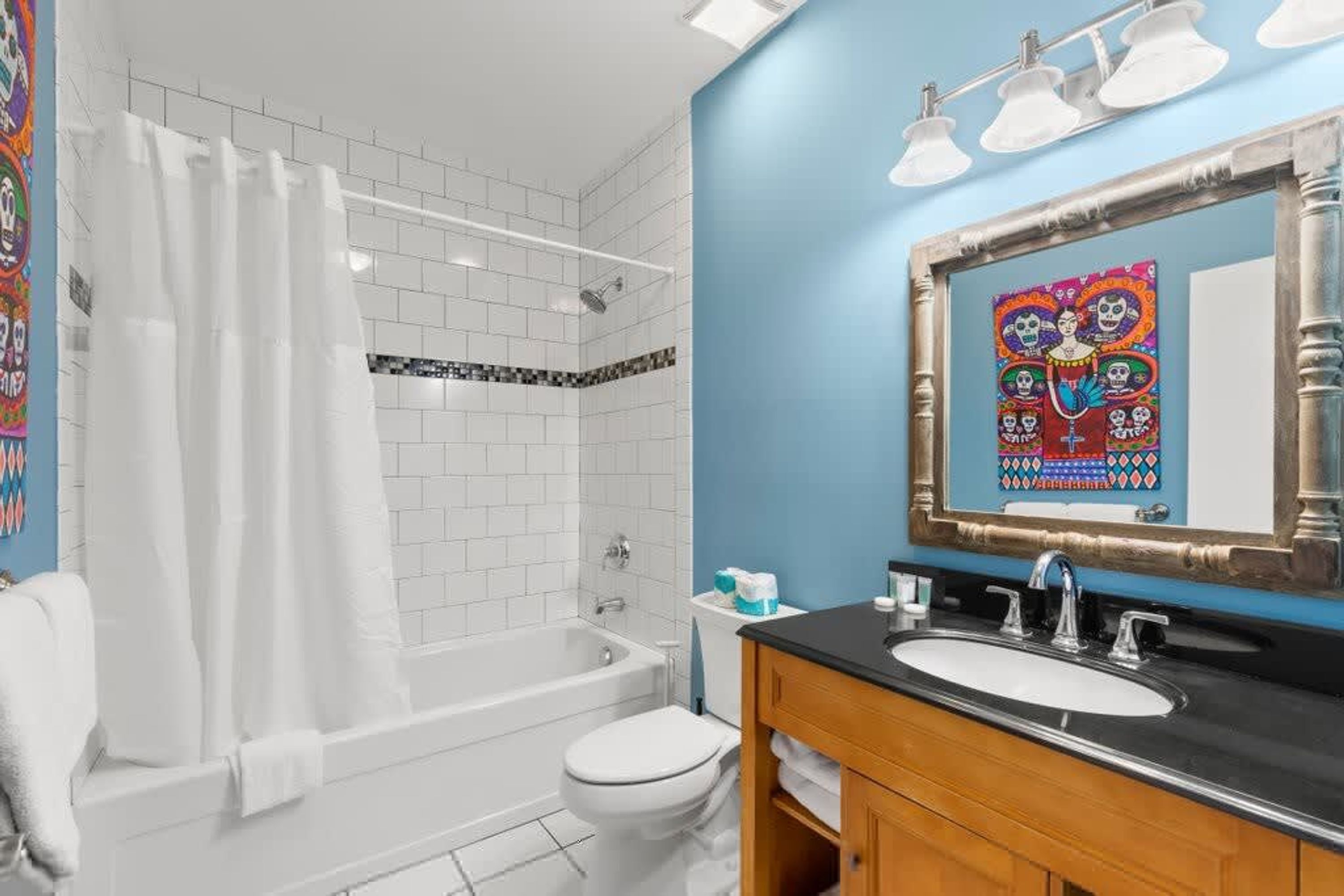 A bathroom with a bathtub, toilet, and sink.