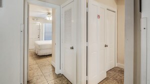 A hallway with white doors, one of which has a 'no smoking' sign. - Sea Breeze by Brightwild Off-street Parking (Key West)