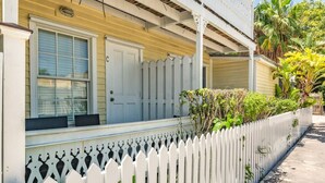 A white picket fence, a porch, and a door with a window. - Sea Breeze by Brightwild Off-street Parking (Key West)