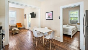 A modern apartment with a dining area, a kitchen, and a bedroom. - Bananas Foster by Brightwild Epic Guesthouse (Key West)