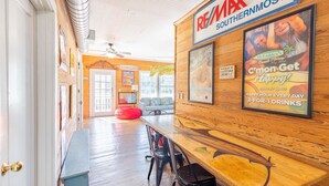 A restaurant interior with wooden walls, a bar area, and a seating arrangement.