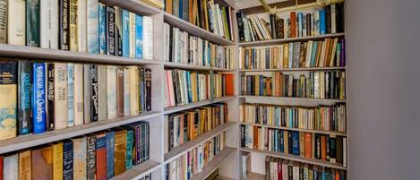 A library with multiple bookshelves filled with books.