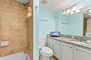 A bathroom with a bathtub, toilet, and sink. - Oceanfront Penthouse Pool Hot Tub Beach Access (Daytona Beach Shores)