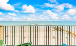 A balcony with a view of a beach and a pier. - Breathtaking Views Heated Pool Beach Access (Daytona Beach Shores)
