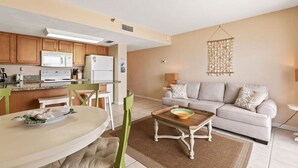 A compact living space with a kitchen, dining area, and seating area. - Ocean Front Condo w Amazing Views Pool Hot Tub (Daytona Beach Shores)