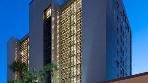 A modern hotel with a prominent entrance, a covered outdoor seating area, and a well-lit facade. - Reflections 504 Oceanfront Pool Beach View (Indian Rocks Beach)