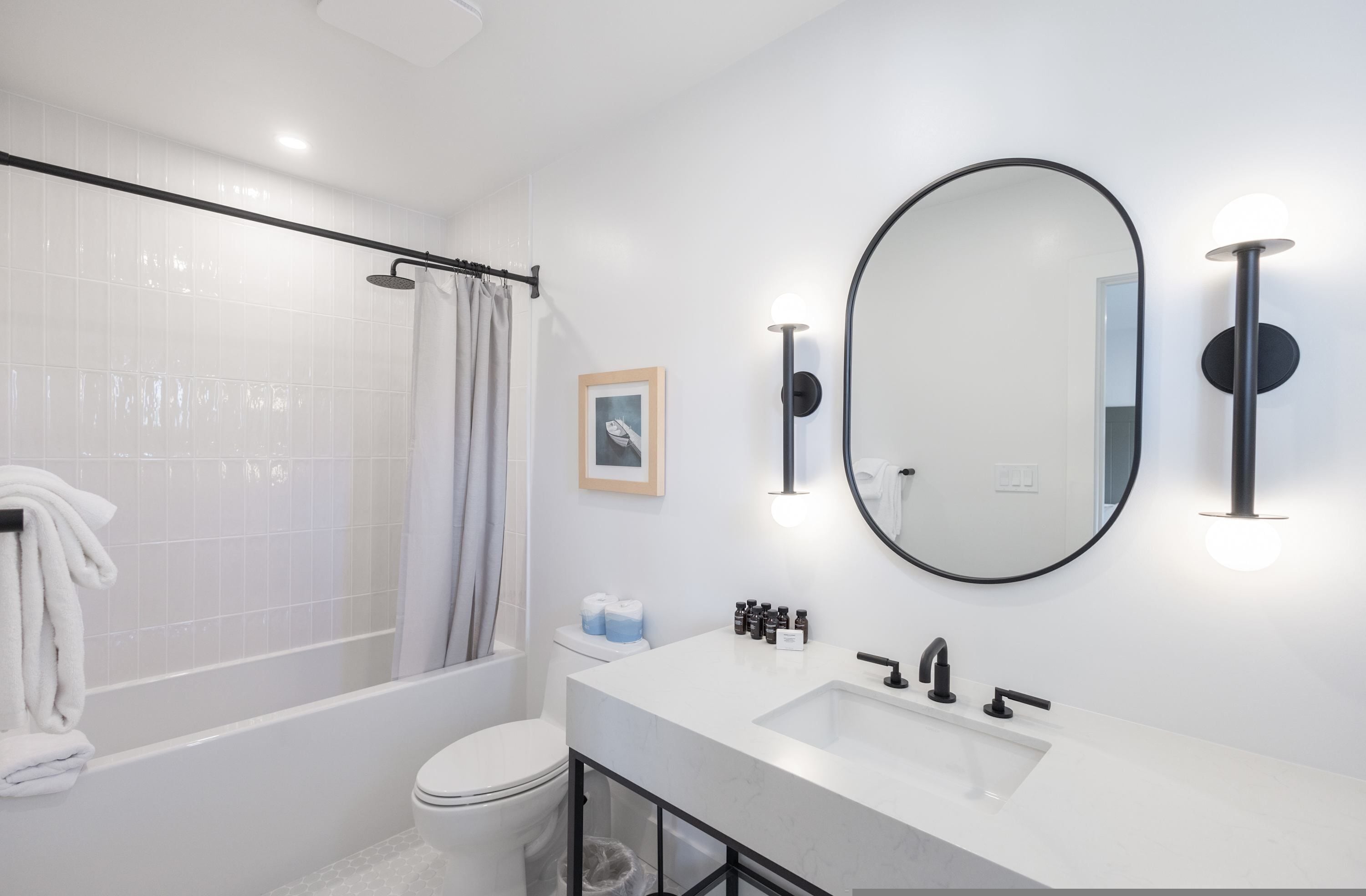 A modern bathroom with a bathtub, toilet, and sink.