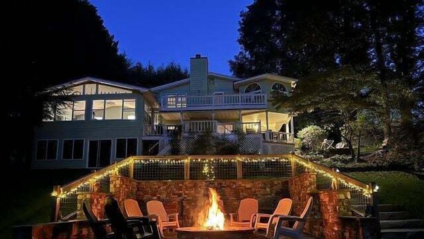 A large house with a fire pit and outdoor seating. - Living the Dream- Lakefront-Dock (Hiawassee)