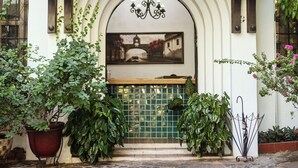 A hotel entrance with a sign reading "Hostal Las Marias," a tiled entrance, and potted plants. - Hotel Las Marias (Taxisco)