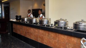 A buffet setup with multiple food containers on a counter. - WestPoint Hotels Limited (Abuja)