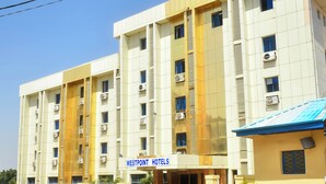 A multi-story hotel with a sign reading "Westpoint Hotels". - WestPoint Hotels Limited (Abuja)