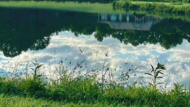A house with a porch and a gazebo by a pond. - Green Acres (Minford)