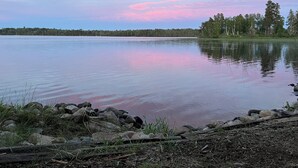 A calm lake with a forested shoreline and a clear sky. - Charming vintage lakefront cabin w/ Wifi in BWCA (Ely)