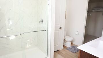Een douche, handdoeken, zeep, shampoo