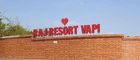 A sign for Raj Resort Vapi with a heart symbol above the text.