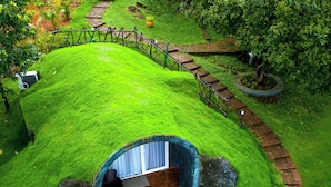 A house with a grass-covered roof and a circular interior. - Sandal Mist Resort and spa  (Kasaragod)