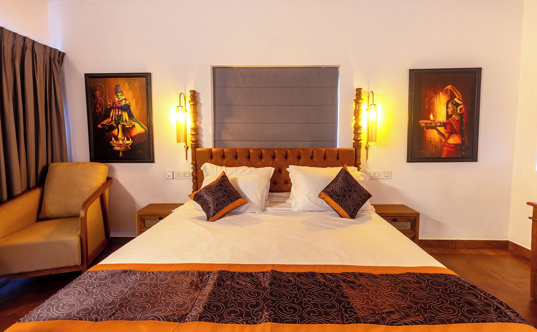 Une chambre d’hôtel avec un grand lit, deux tables de chevet, une chaise et deux lampes fixées au mur.