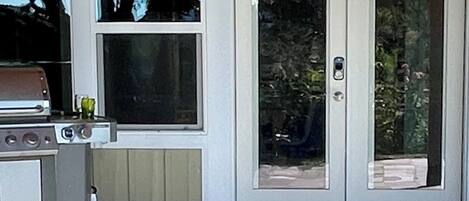 A garage door with a grill and a window above it.