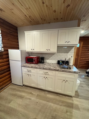 Fridge, microwave, coffee/tea maker, cookware/dishes/utensils