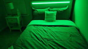A bedroom with a bed, a nightstand, and a lamp. - Newly Built Getaway! (Columbia)