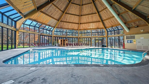 A large indoor swimming pool with a wooden ceiling and large windows. - Slopeside Escape by Avantstay Walk to Ski Lifts Arcade Games + Shuffleboard (Tannersville)