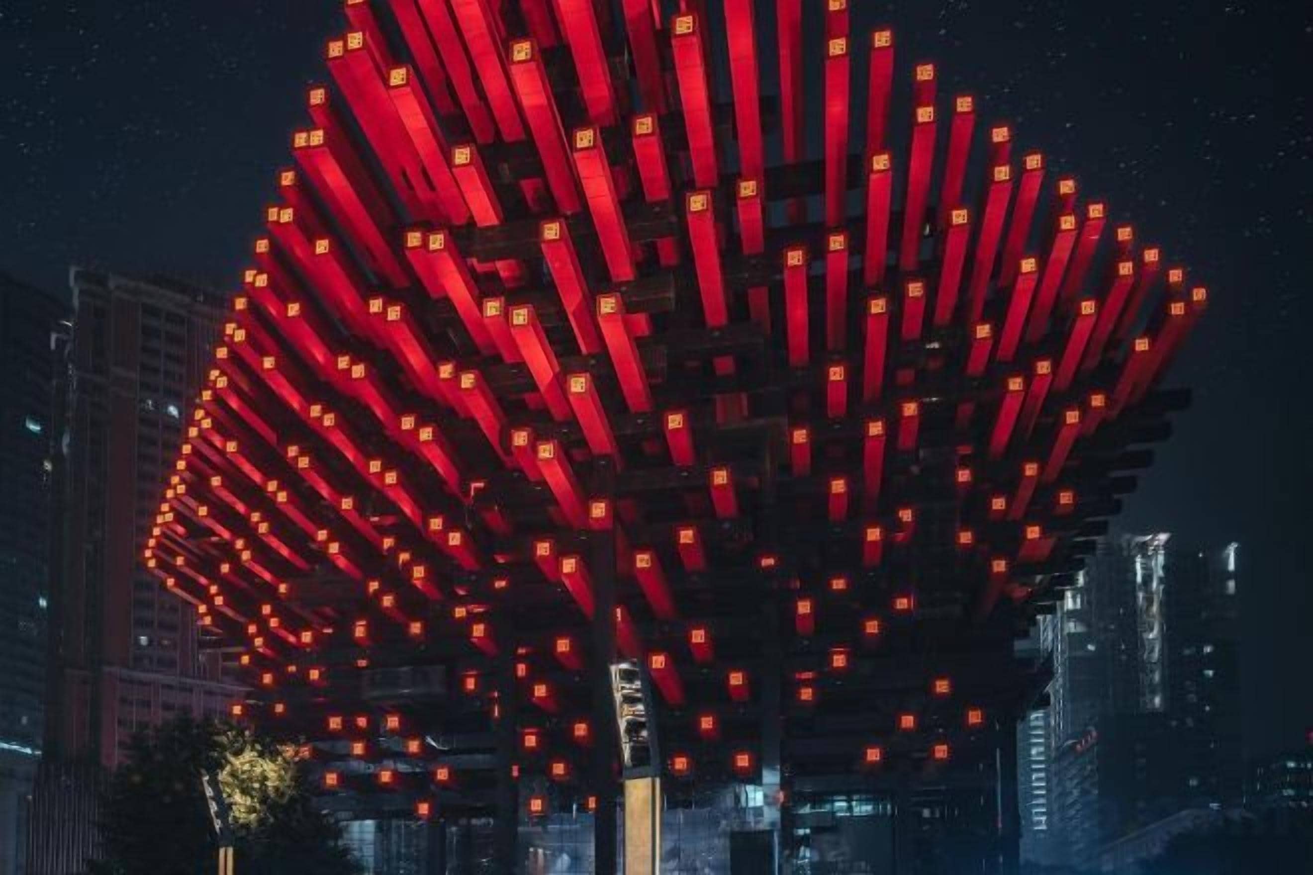 A large, illuminated structure with multiple vertical elements, possibly a landmark or building.