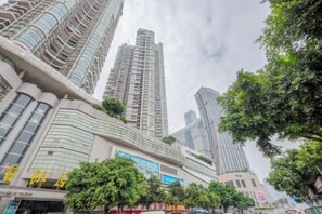 A cityscape with high-rise buildings, including a prominent curved structure and a tall skyscraper. - Meitu Apartment Hotel (Chongqing Jiefangbei Chaotianmen Branch) (Chongqing)