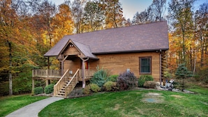 A log cabin with a wooden deck and a staircase leading to a porch. - 3 Irish Sons, 4BR, 3 BA  Log Cabin in the woods. (Nashville)