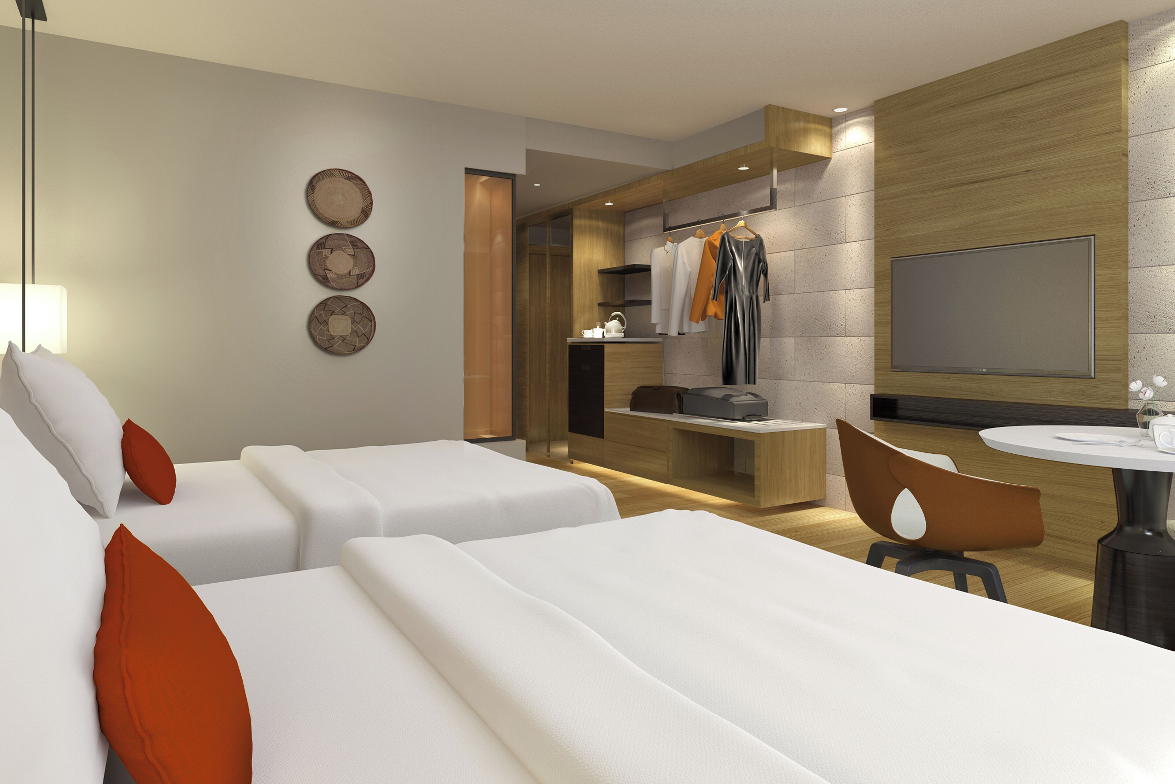 A modern hotel room with two beds, a sitting area with a table and chairs, a TV mounted on the wall, and a small kitchenette.