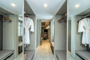 A hotel corridor with mirrored walls, a central walkway, and a seating area with a table and chairs. - Layana Resort & Spa (Koh Lanta)