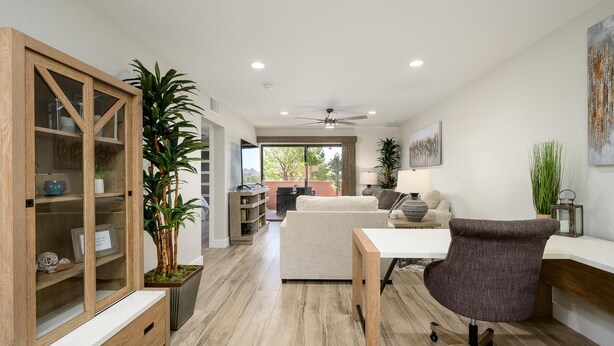 A modern living room with a wooden cabinet, a dining table, and a comfortable sofa.